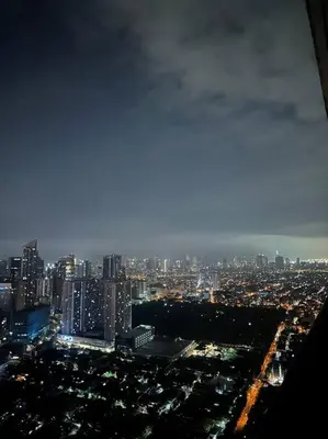 a view of a city at night with at Gramercy Residences Two Bedroom on 60th Floor in Manila