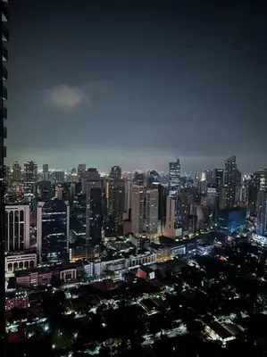 a view of a large city at night at Gramercy Residences Two Bedroom on 60th Floor in Manila
