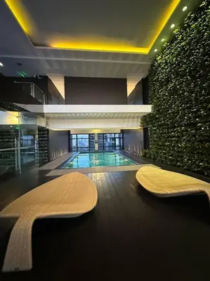 a swimming pool with a bench in a building at Spacious 1 Bedroom in Gramercy 2 balconies in Manila