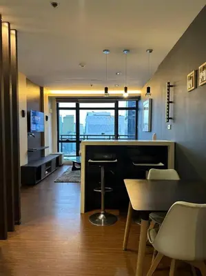 a room with a bar with a table and chairs at Spacious 1 Bedroom in Gramercy 2 balconies in Manila