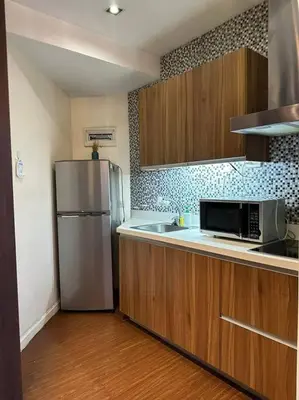 a kitchen with a stainless steel refrigerator and a sink at Spacious 1 Bedroom in Gramercy 2 balconies in Manila