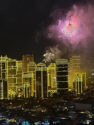 a fireworks display in a city with buildings at Spacious 1 Bedroom in Gramercy 2 balconies in Manila