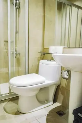 a bathroom with a toilet and a sink at 52F Sunset View Studio in Gramercy Pool Gym Sauna in Manila