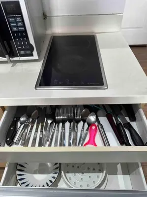 a drawer filled with utensils in a refrigerator at 52F Sunset View Studio in Gramercy Pool Gym Sauna in Manila