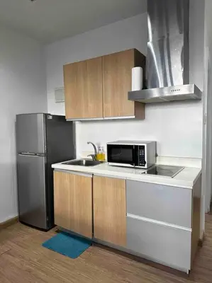 a kitchen with a sink and a refrigerator at 52F Sunset View Studio in Gramercy Pool Gym Sauna in Manila