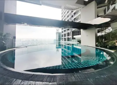 a swimming pool in the middle of a building at 52F Sunset View Studio in Gramercy Pool Gym Sauna in Manila