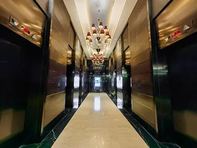 a hallway in a building with a chandelier at 52F Sunset View Studio in Gramercy Pool Gym Sauna in Manila