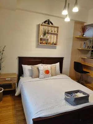 a bedroom with a large bed with a flower on it at Tessa's Place Staycation 4FI in Jalang
