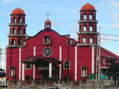 a red building with two towers on top of it at Tessa's Place Staycation 4FI in Jalang