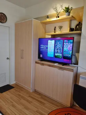a flat screen tv sitting on top of a wooden cabinet at Tessa's Place Staycation 4FI in Jalang