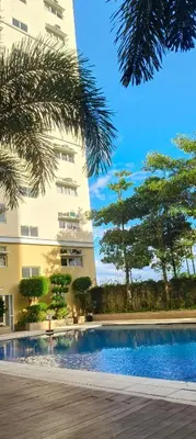 a swimming pool in front of a building at Tessa's Place Staycation 4FI in Jalang