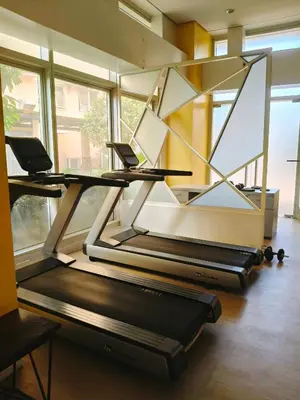 a gym with three treadmills in a room with windows at Tessa's Place Staycation 4FI in Jalang