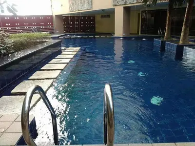 a swimming pool with blue water in a building at Studio 203 T2 Sunshine100 Wifi PoolAccess BunkBed SofaBed in Manila