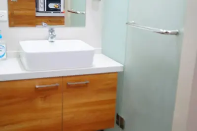 a bathroom with a white sink and a mirror at Studio 203 T2 Sunshine100 Wifi PoolAccess BunkBed SofaBed in Manila