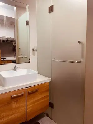 a bathroom with a sink and a shower with a mirror at Studio 203 T2 Sunshine100 Wifi PoolAccess BunkBed SofaBed in Manila