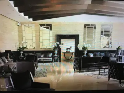 a living room with couches and a fireplace at Spacious Corner 1 Bedroom with Balcony Gramercy in Manila