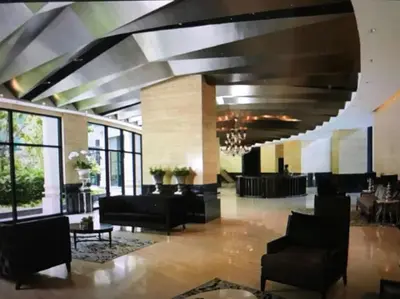 a lobby with couches and chairs in a building at Spacious Corner 1 Bedroom with Balcony Gramercy in Manila