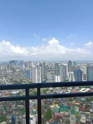 a view of a large city from a balcony at 58F Minimalist Studio Panoramic View in Gramercy in Manila