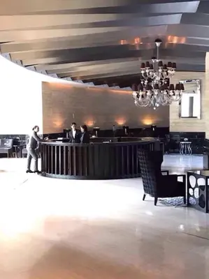 a restaurant with people standing at a bar at 58F Minimalist Studio Panoramic View in Gramercy in Manila