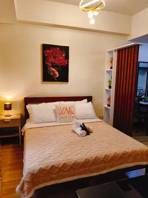 a bedroom with a bed with a home sign on it at Tessa's Place Staycation 10FI in Jalang