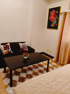 a living room with a couch and a coffee table at Tessa's Place Staycation 10FI in Jalang
