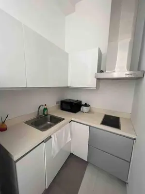 a small kitchen with a sink and a microwave at 64F Spacious 1 BR Nice View Pool Sauna Gym in Manila