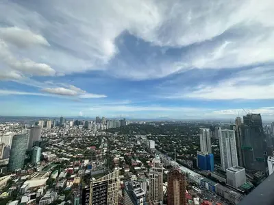 a view of a city from the top of a building at 68F 1 Bedroom Penthouse Suite Gramercy Pool Sauna in Manila