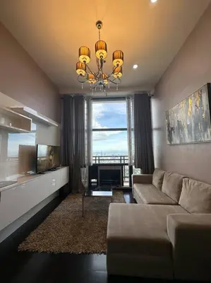 a living room with a couch and a large window at 68F 1 Bedroom Penthouse Suite Gramercy Pool Sauna in Manila