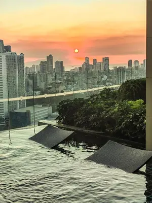 a view of a city at sunset from a building at 68F 1 Bedroom Penthouse Suite Gramercy Pool Sauna in Manila