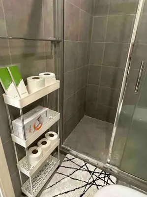 a bathroom with a shower and a toilet and towels at 45F Gramercy Corner Studio Wifi Netflix SmartTV free use Pool Gym in Manila