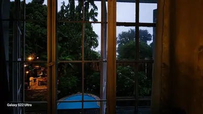 an open window looking out onto a garden at Elegant Villa in Manila