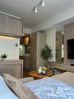 a bedroom with a bed and a living room at El Suite in Puting Kahoy