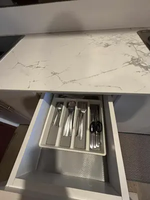 a table with utensils sitting on a shelf at El Suite in Puting Kahoy