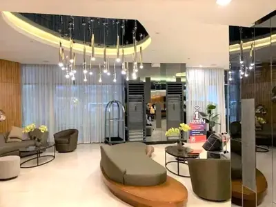 a lobby with a couch and chairs and a chandelier at Straightforward 1 BR Shore 2 Residences near MOA NAIA PICC in Manila