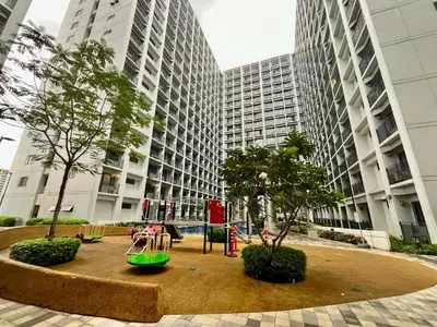a playground in front of a building with tall buildings at Straightforward 1 BR Shore 2 Residences near MOA NAIA PICC in Manila