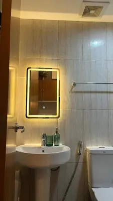 a bathroom with a sink and a mirror and a toilet at 8Adriatico Penthouse Studio Unit! Walk Away to US Embassy and St Lukes Ermita in Manila