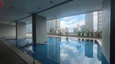 a large swimming pool with a view of a city at 8Adriatico Penthouse Studio Unit! Walk Away to US Embassy and St Lukes Ermita in Manila