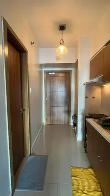 a kitchen with a hallway with a door to a room at 8Adriatico Penthouse Studio Unit! Walk Away to US Embassy and St Lukes Ermita in Manila