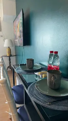 a glass table with two bottles of water on it at 8Adriatico Penthouse Studio Unit! Walk Away to US Embassy and St Lukes Ermita in Manila