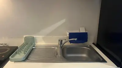 a kitchen sink with a dish rack next to it at 8Adriatico Penthouse Studio Unit! Walk Away to US Embassy and St Lukes Ermita in Manila