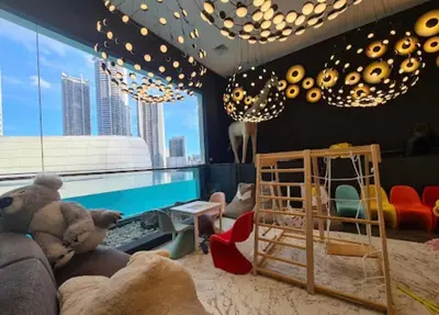 a childrens room with a pool and a bed with a crib at Novotel Residences ACQUA near Rockwell Makati in Manila
