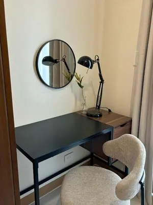 a desk with two lamps and a mirror on a wall at Cozy Space in Makati - Margareth Suite in Manila