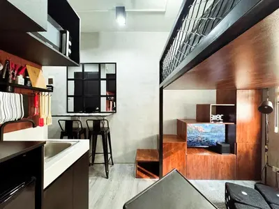 a small kitchen with a sink and a staircase at Urban Hive 1821 in Manila