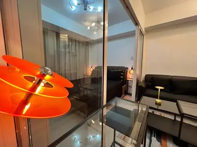 a living room with a glass table and a couch at Azure Playfull Living 1 bedroom in Manila