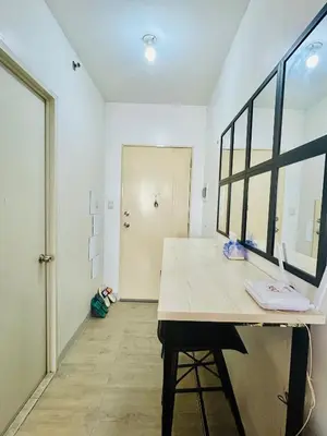 a room with a white counter and a large window at Cozy Studio Unit Near MRT Shaw & Malls in Manila