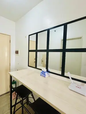a desk with a large window in a room at Cozy Studio Unit Near MRT Shaw & Malls in Manila