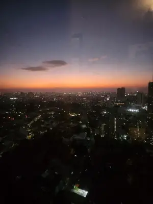 a view of a city at night at Cozy Studio Unit Near MRT Shaw & Malls in Manila