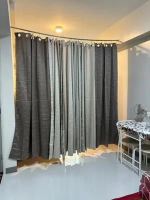 a curtain in a room with a table at Solana Tower 1 New and Very Neat Studio Unit near SM Manila in Manila