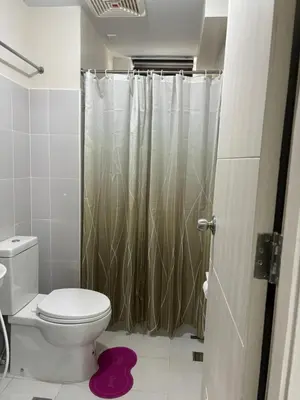 a bathroom with a toilet and a shower at Solana Tower 1 New and Very Neat Studio Unit near SM Manila in Manila