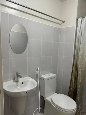 a bathroom with a toilet and a sink and a mirror at Solana Tower 1 New and Very Neat Studio Unit near SM Manila in Manila